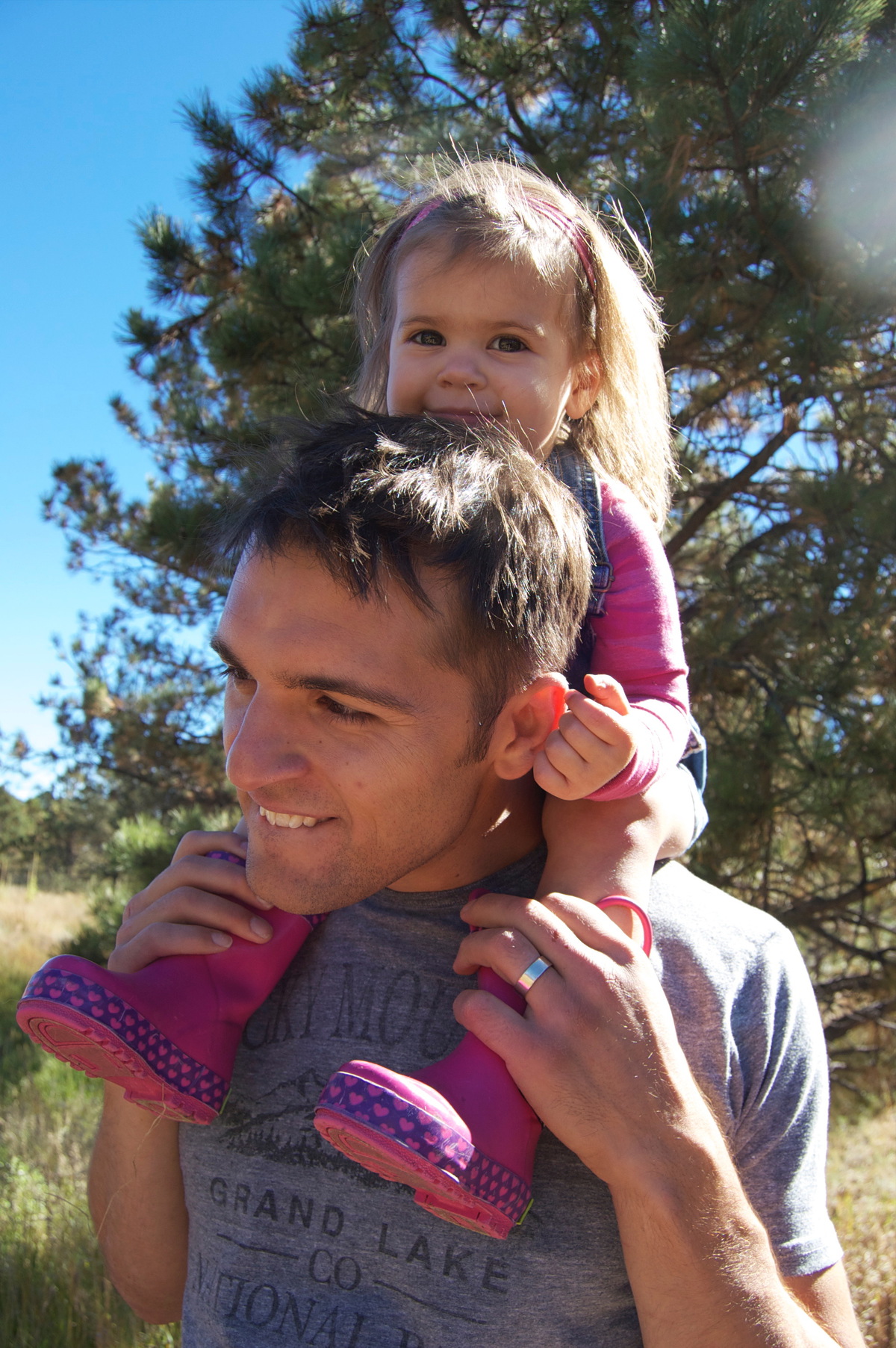 Zach carrying his daughter on his shoulders